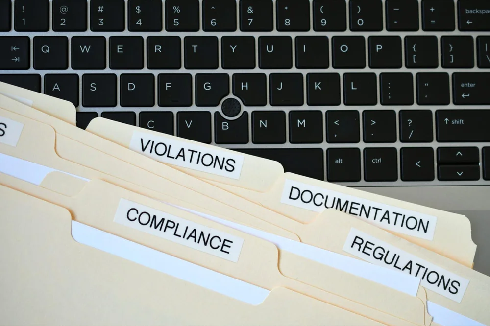 Photo of folders containing marketing compliance violations